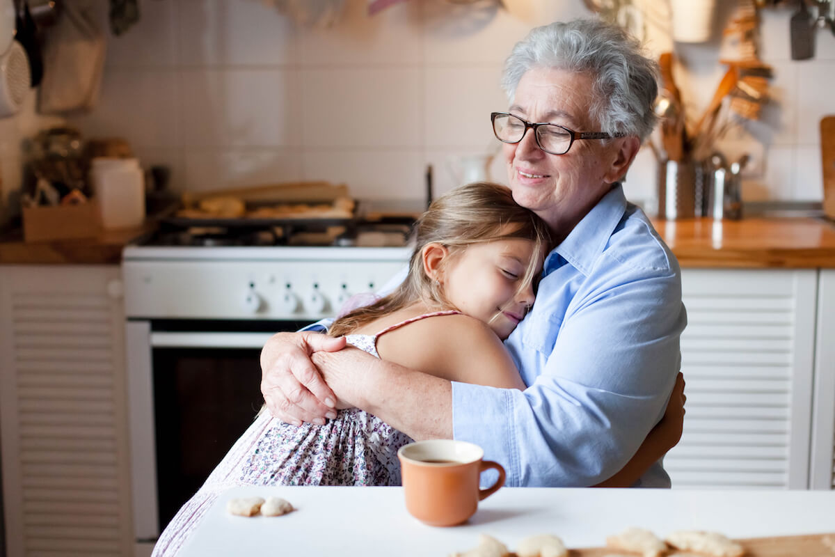 Senior woman hugging child-Explaining dementia to children