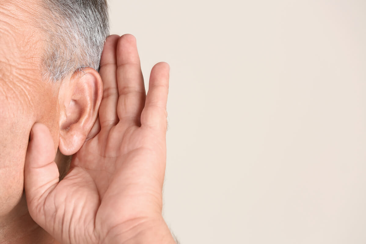 Older man holding hand up to his ear-Understanding hearing loss