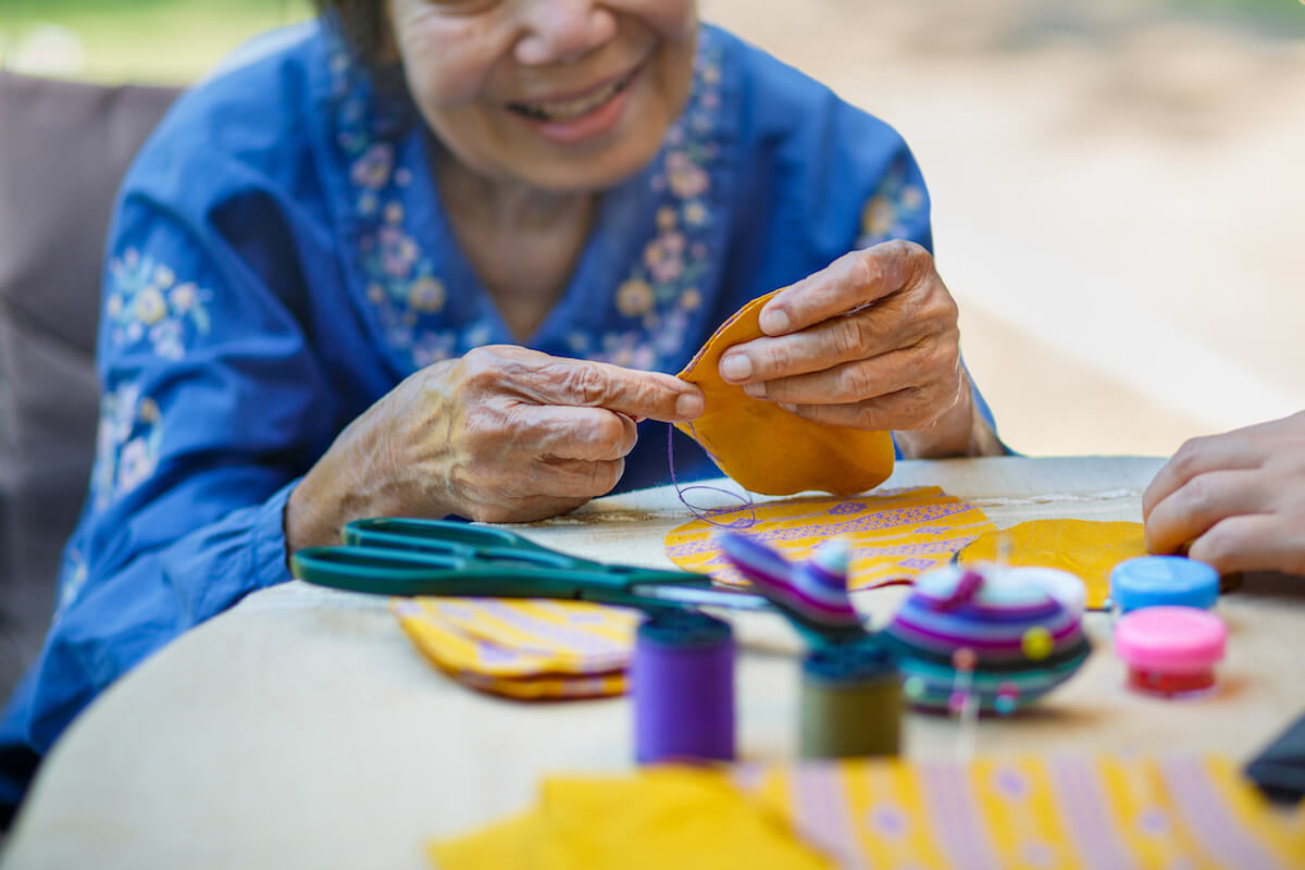 Older Woman Sewing at Table-Dementia Care Activities