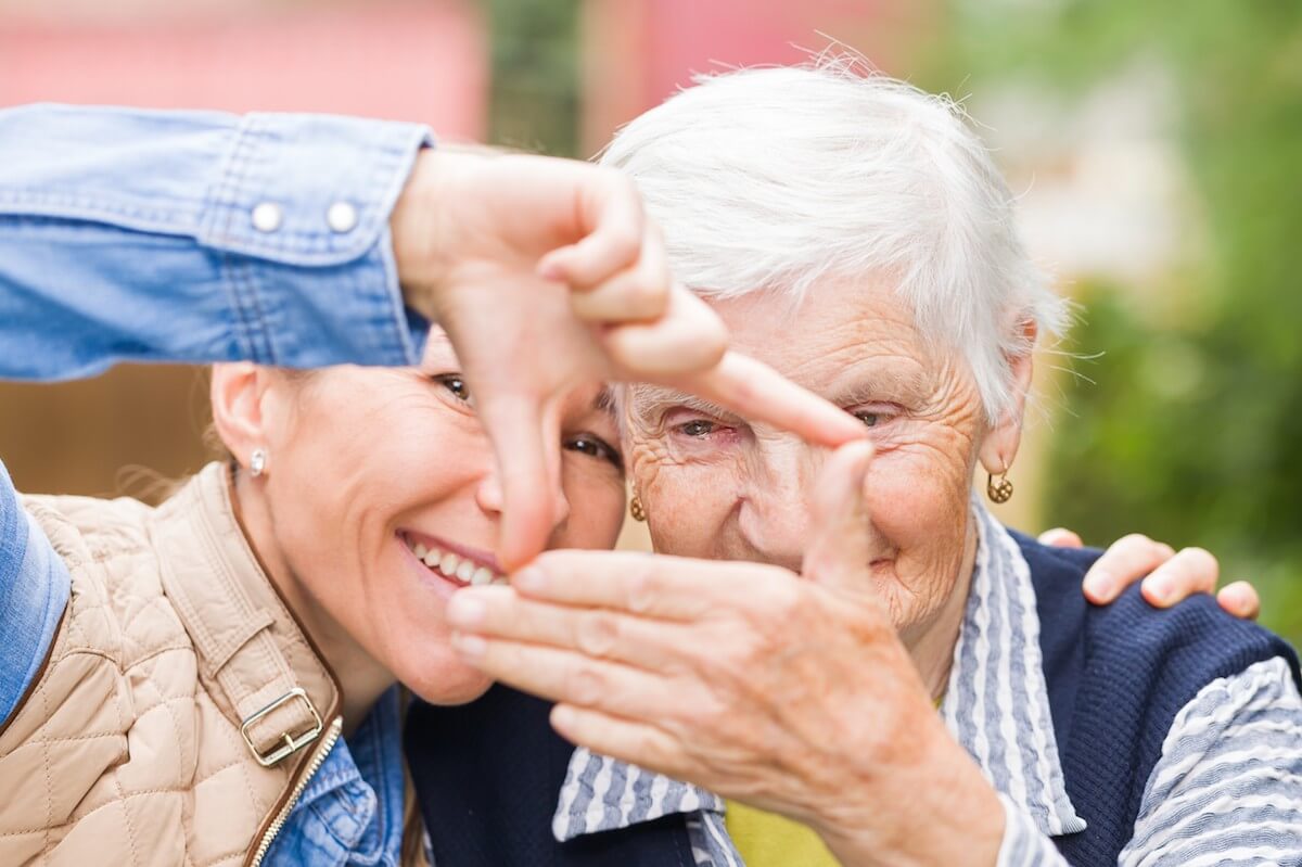 Older Woman and Young Woman Making Rectangle with their Hands-Dementia Care